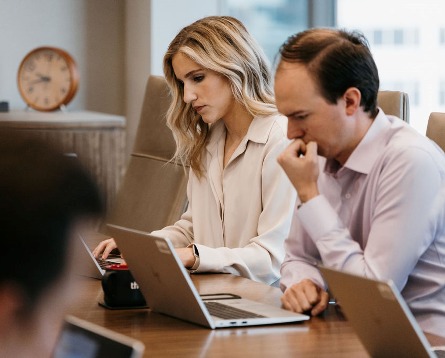 Two people working in a meeting room