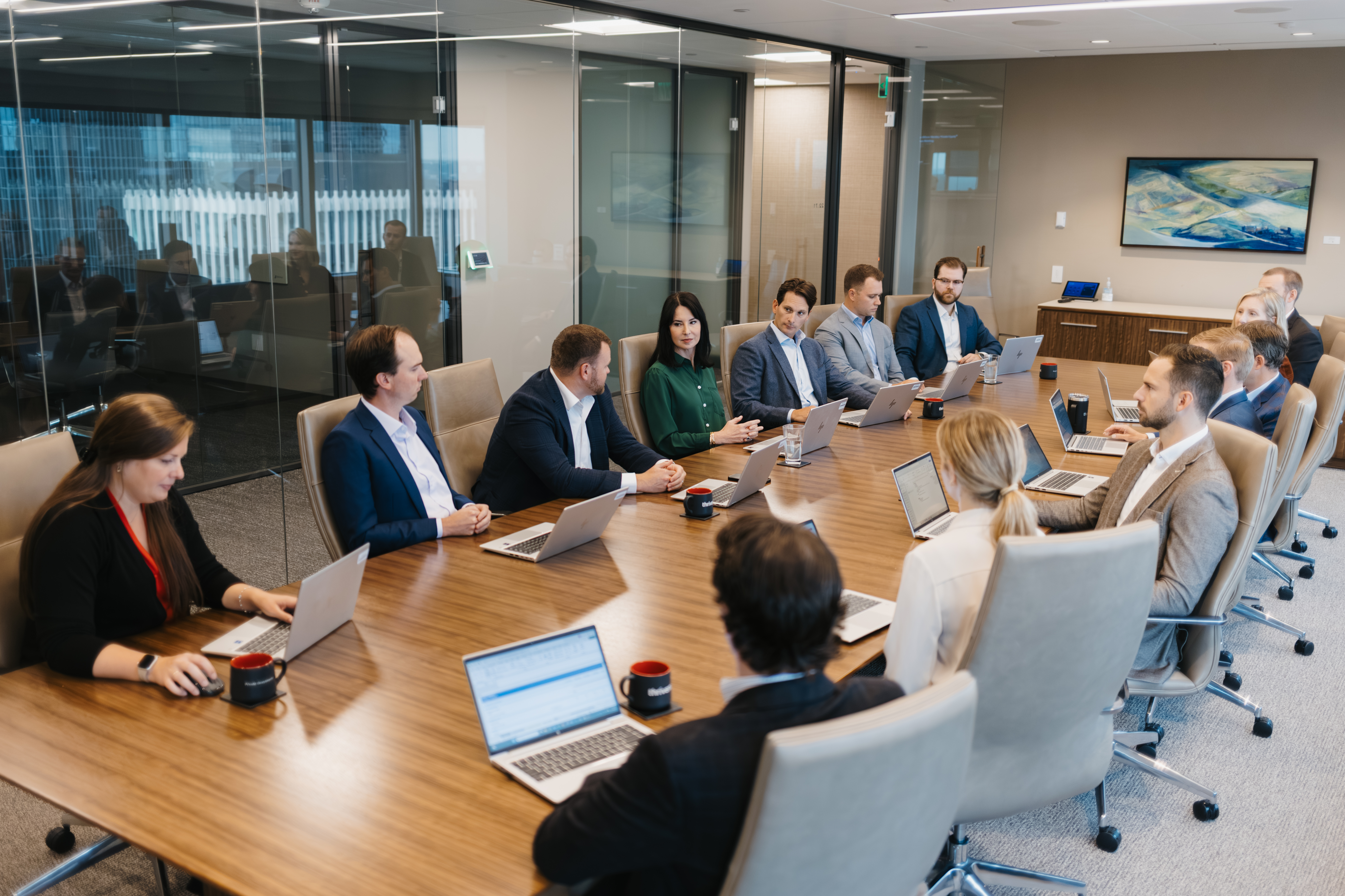 Woman talking in a meeting around a circle table.